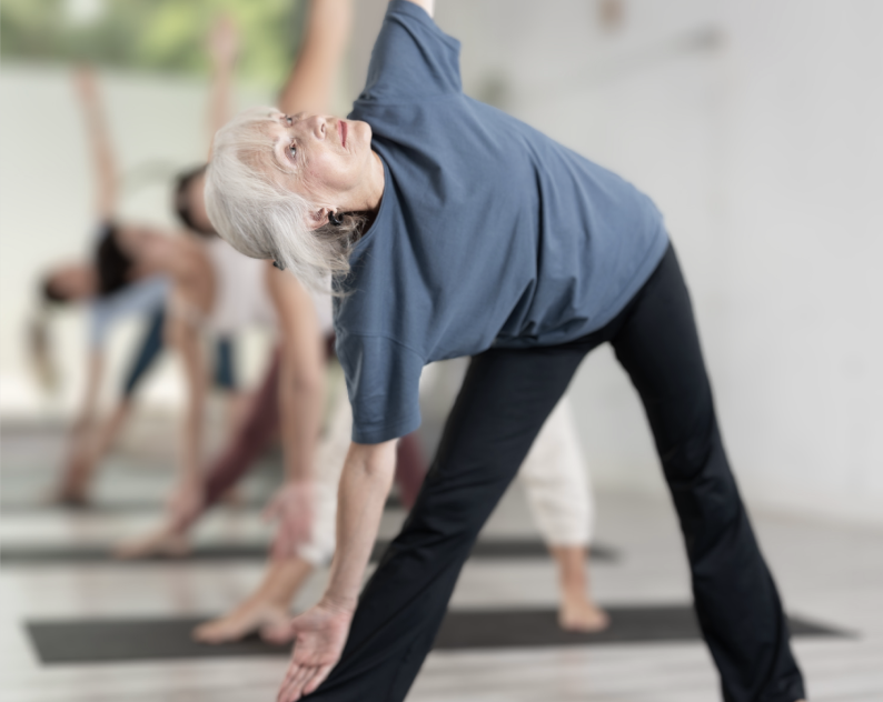 Grey haired woman stretching